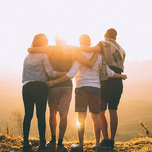 group of people looking at sunset