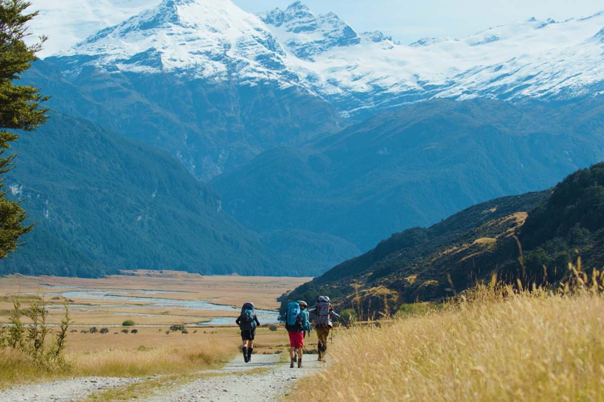 hikers walking towards mountain range 1200x800 v2