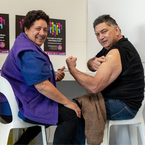 man and woman celebrating getting vaccinated