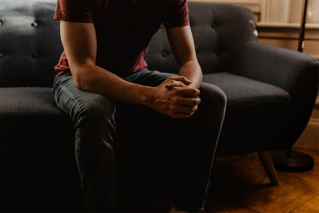 man sitting on couch