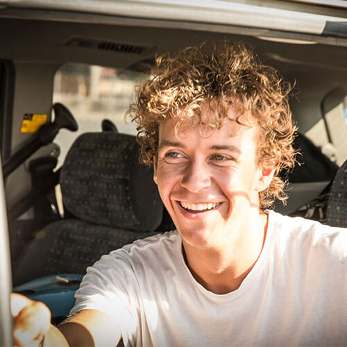 man smiling in car