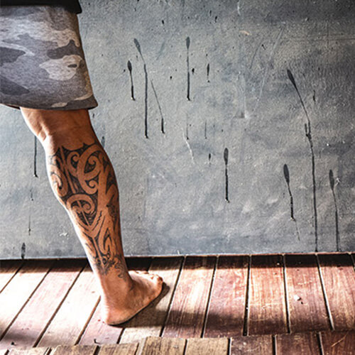 maori tattoos on mans leg