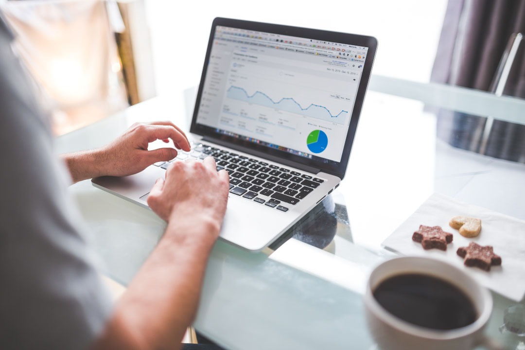 person downloading google analytics data on laptop