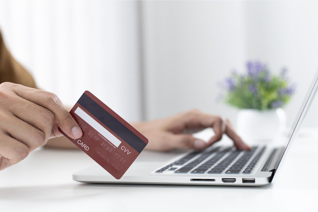 person using credit card to buy something online