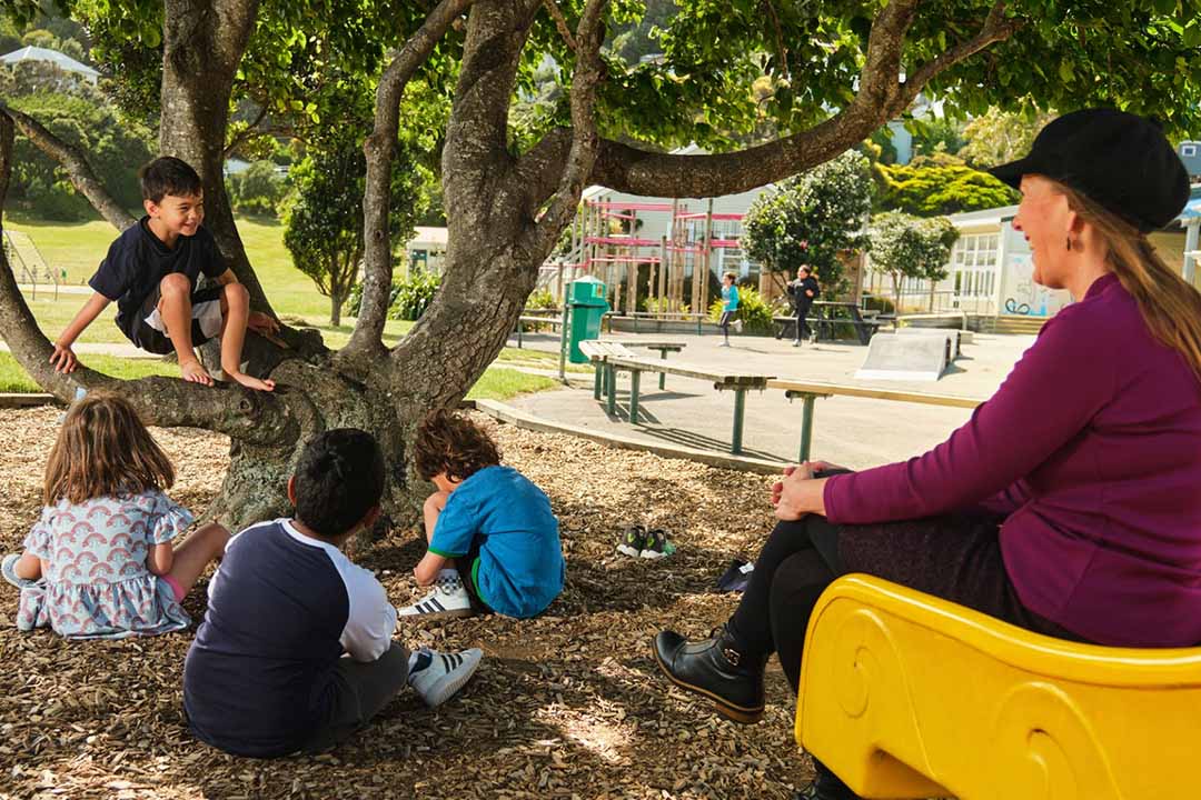 teacher watching students in playground