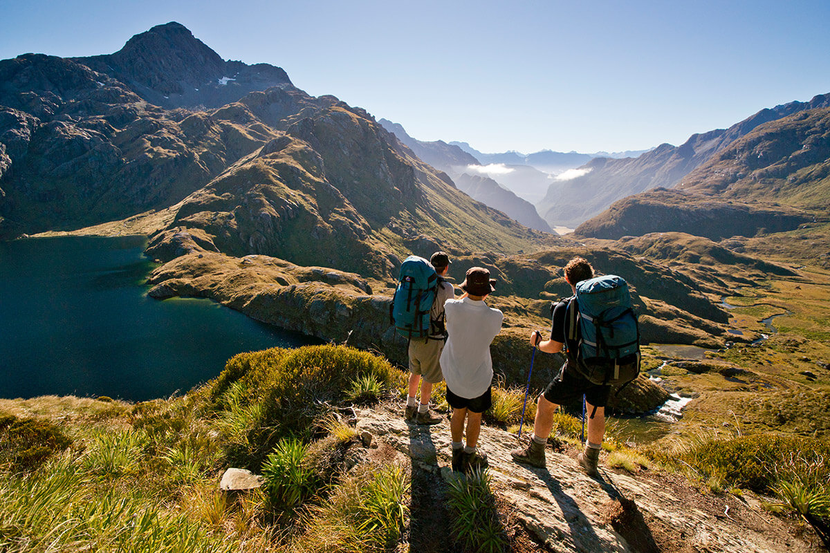 three trampers looking over mountains