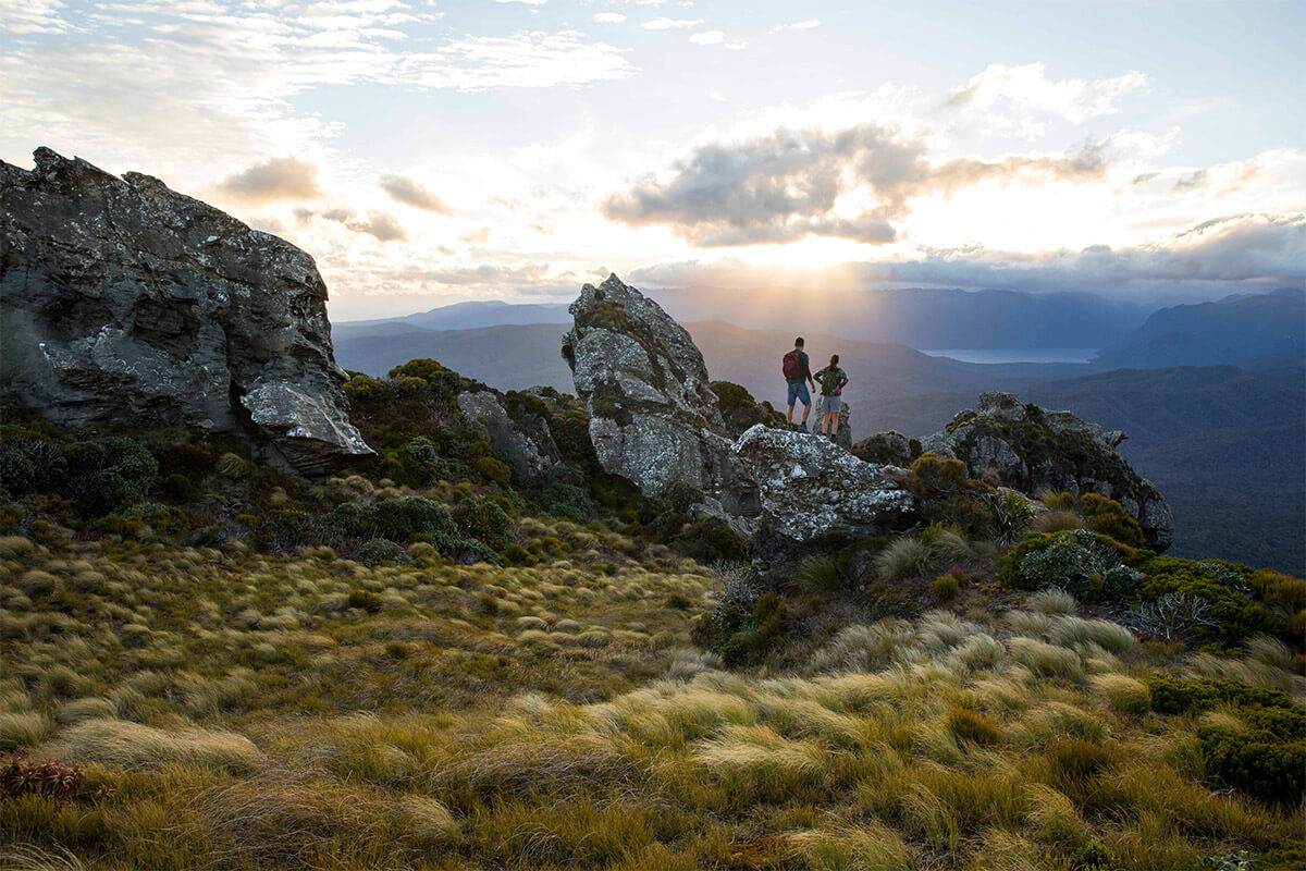 two trampers looking over sunset