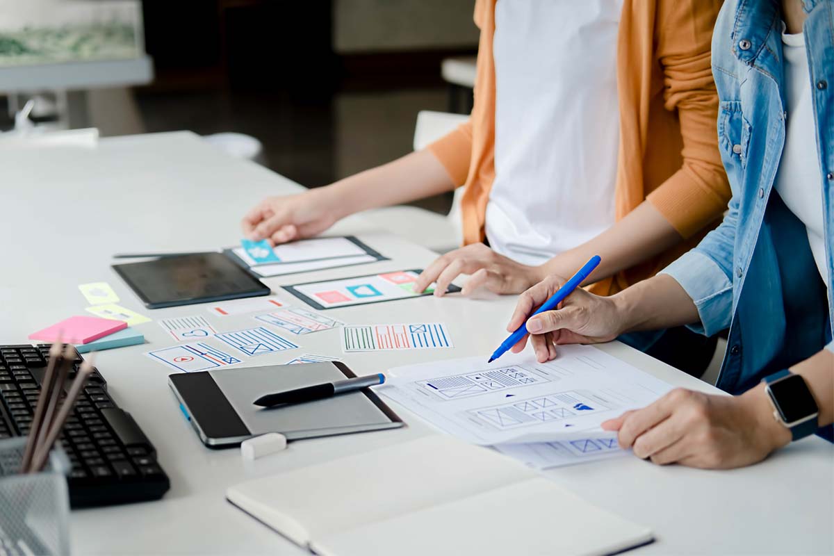 two web designers working on a website design 1200x800