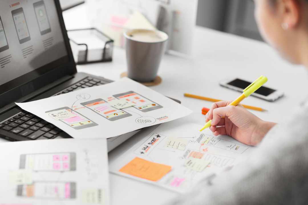 web designer working on laptop on website redesign project